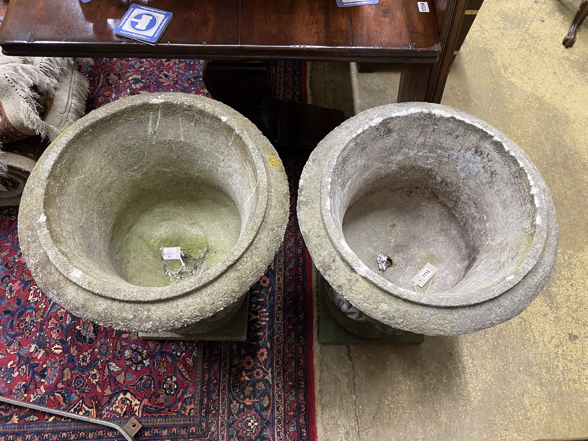 A pair of circular reconstituted stone garden planters, diameter 54cm, height 70cm
